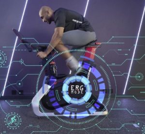 Man on a stationary cycle demostrating ERG mode compatibility of CicloZone, an indoor cycling app